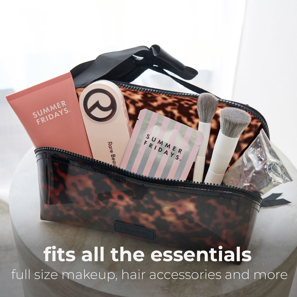Tortoiseshell cosmetic bag filled with full-size makeup and hair accessories