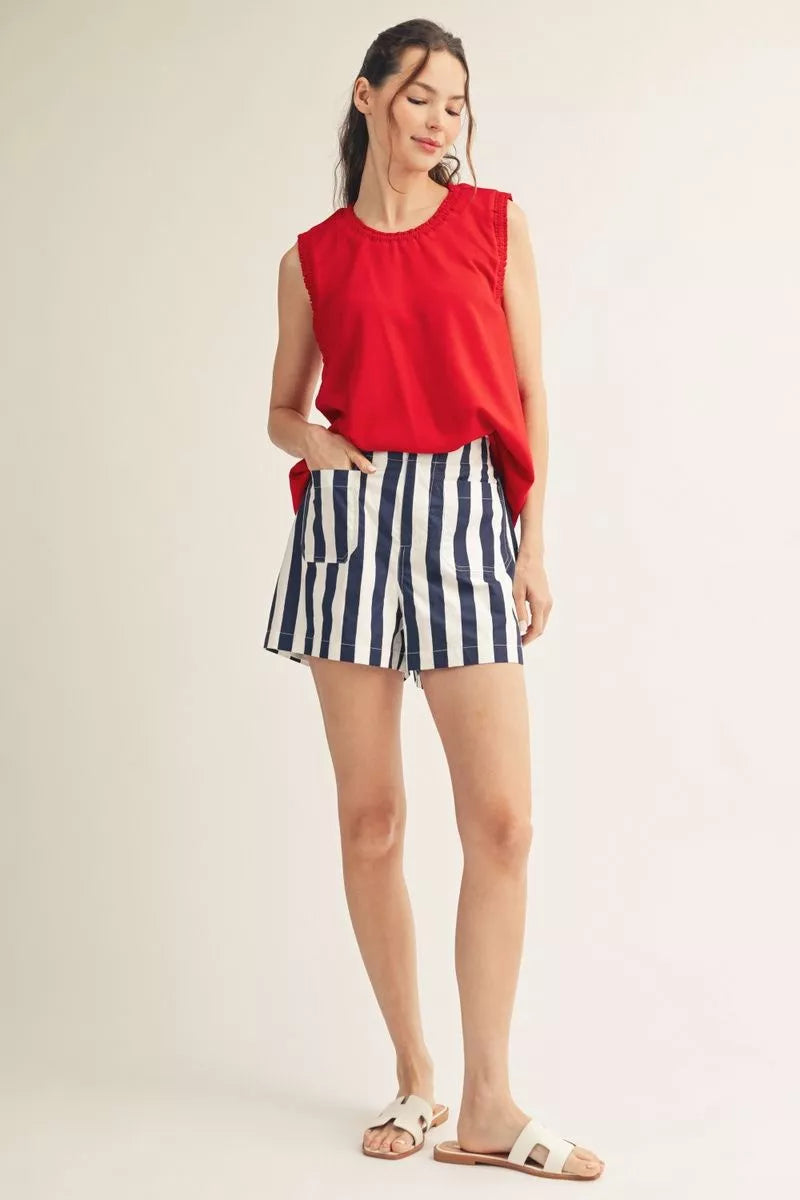 Full-length view of the red tank with striped shorts and white sandals