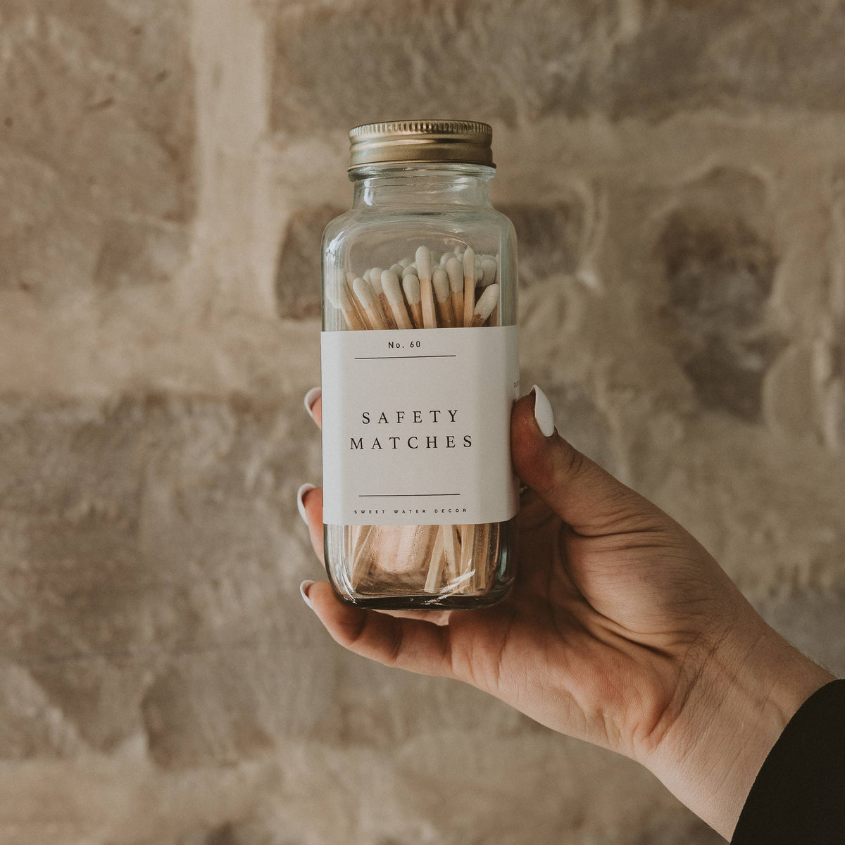 Hand holding the jar of white tip safety matches