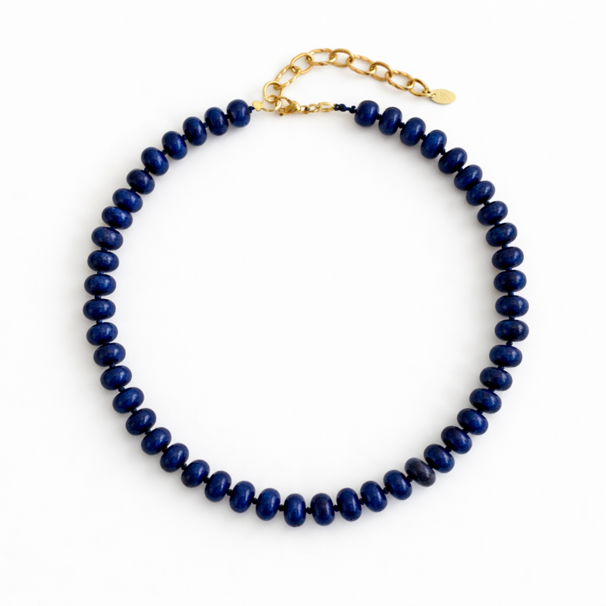 Navy blue beaded necklace with a gold chain on a white background