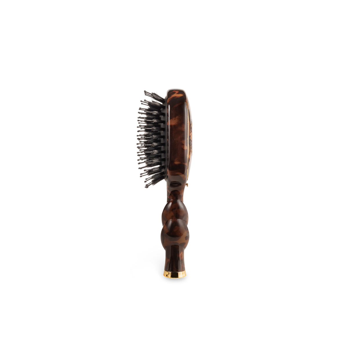 Side view of the tortoise mini boar bristle brush and its coil handle