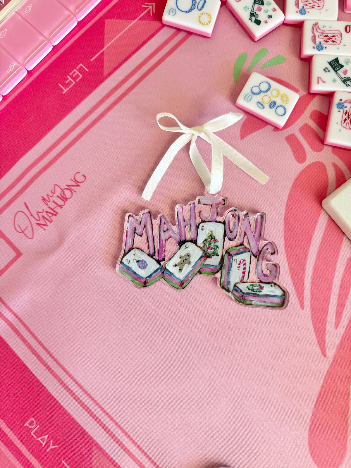 Mahjong Christmas acrylic ornament on a pink Mahjong mat with tiles