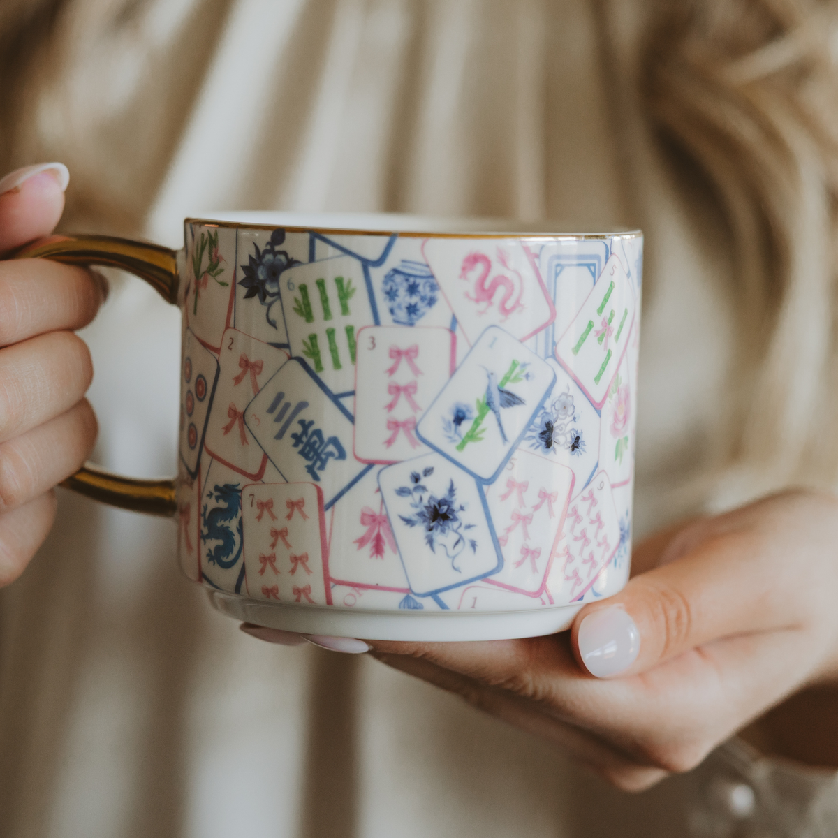 Hands holding the Mahjong tiles coffee mug