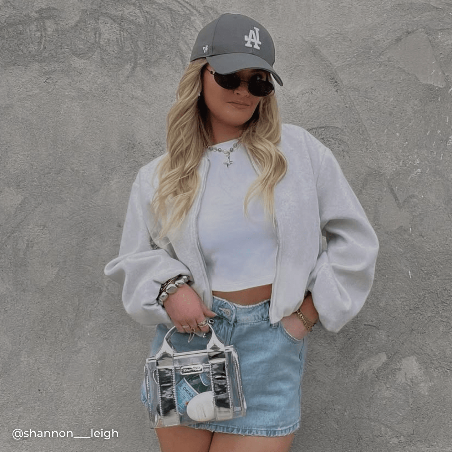 Woman with a clear handbag with silver accents 