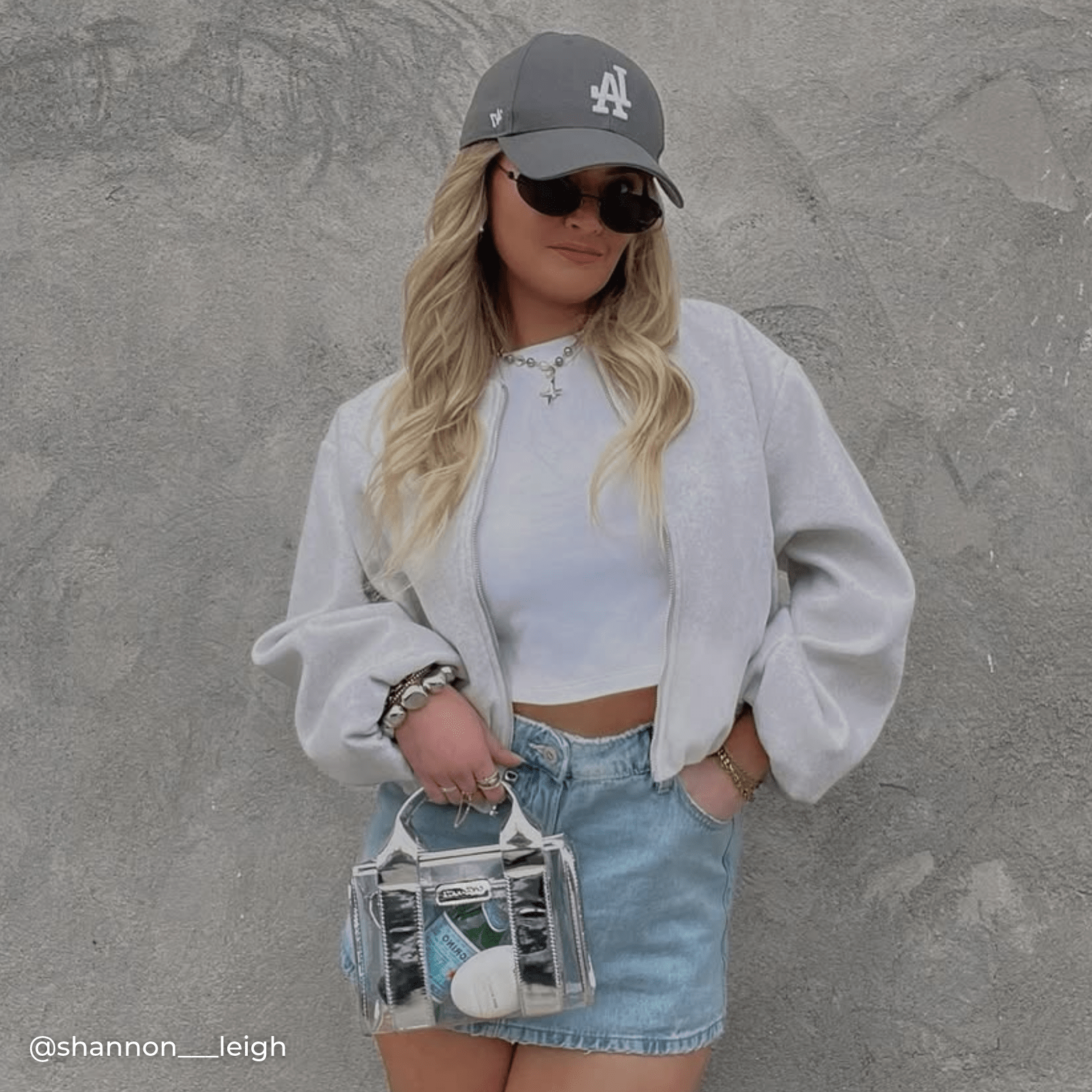 Woman with a clear handbag with silver accents 