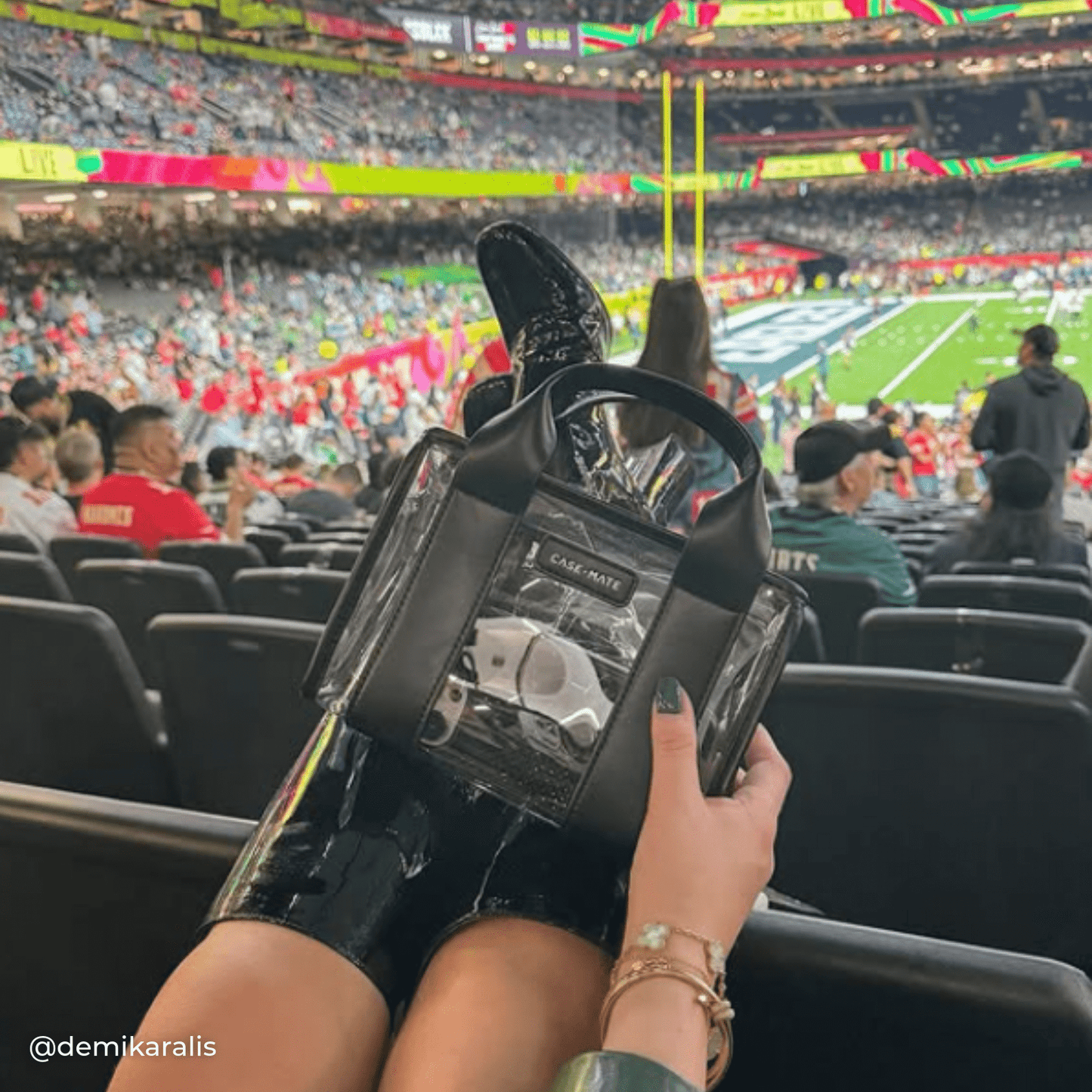 Person holding a  clear bag with black accents at a sporting event