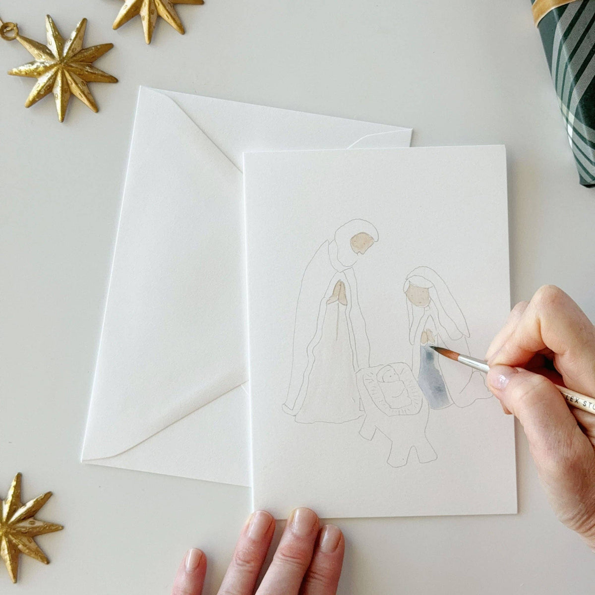 Painting the Holy Family on a nativity notecard