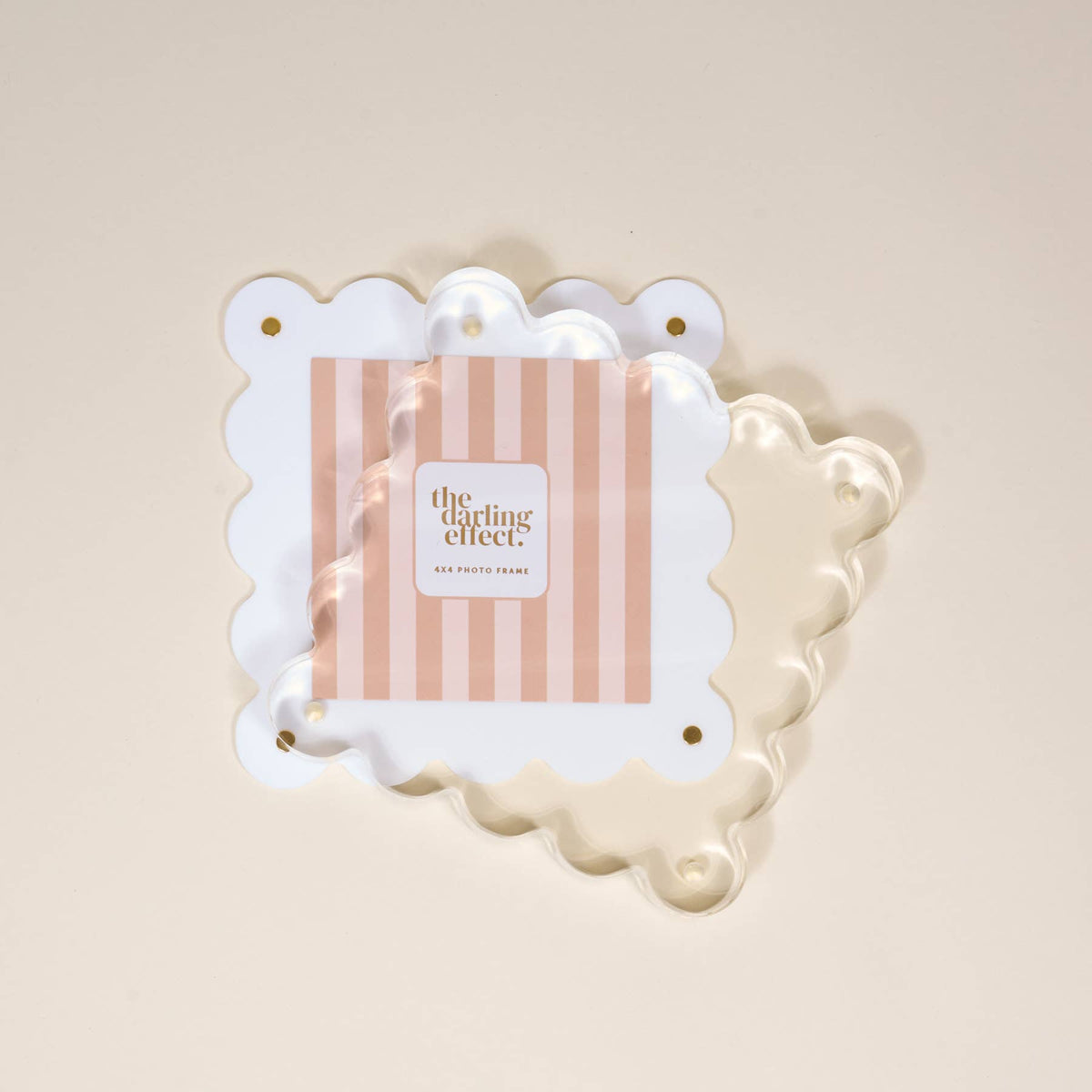 White scalloped acrylic frame displaying a photo