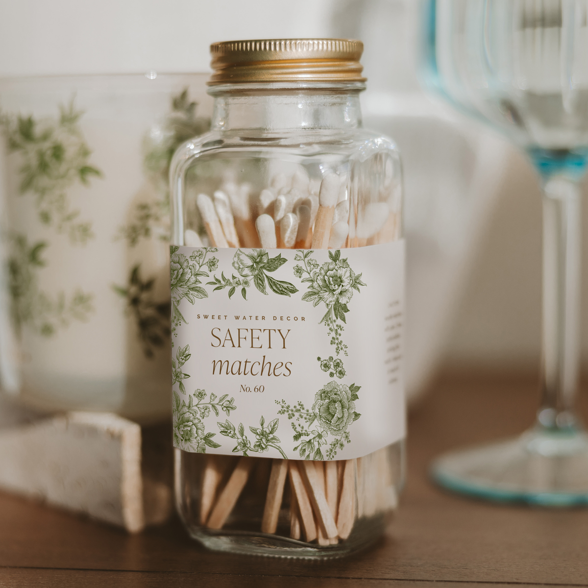 Green Delft safety matches jar on a wood table