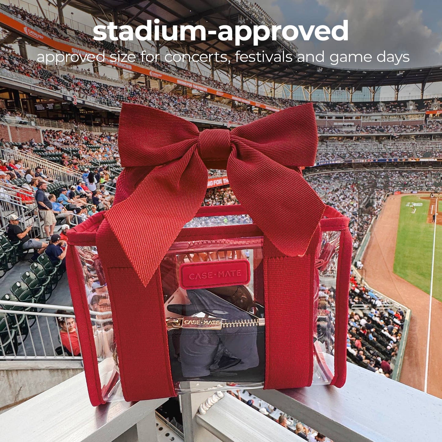 A red transparent zippered CASEHATE bag with a large red bow on top, set against a stadium background