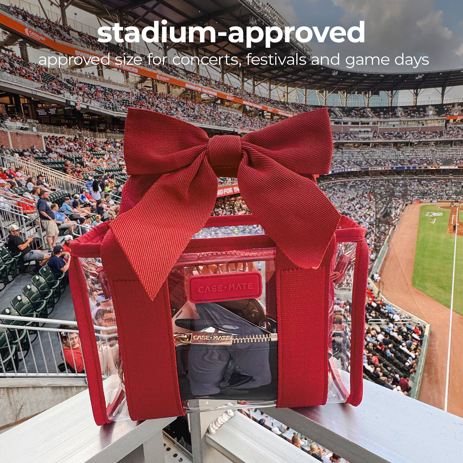 A red transparent zippered CASEHATE bag with a large red bow on top, set against a stadium background