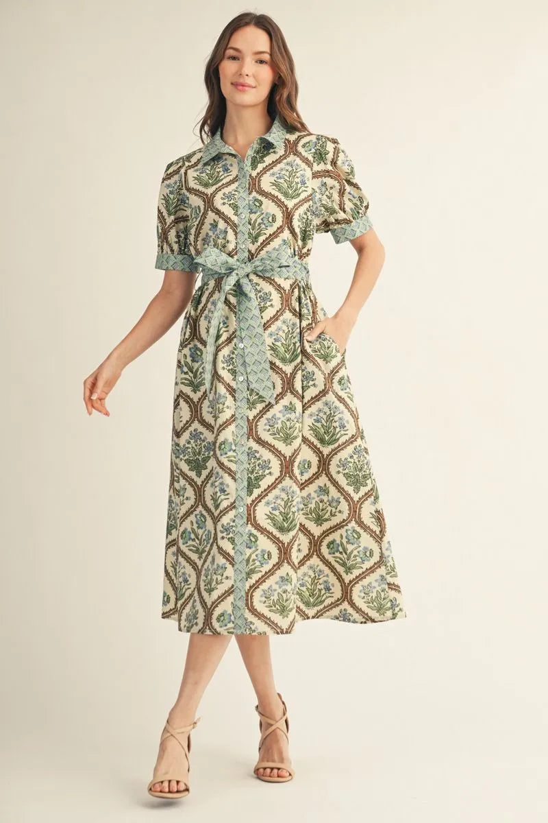 Woman wearing a patterned dress on a plain background