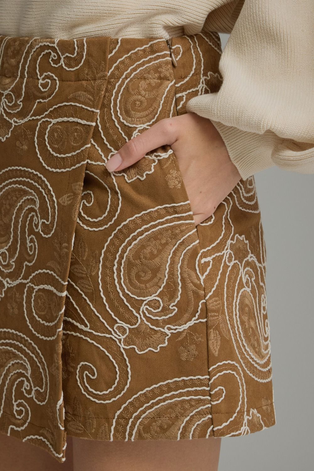 Close-up of camel paisley skort with embroidered detail