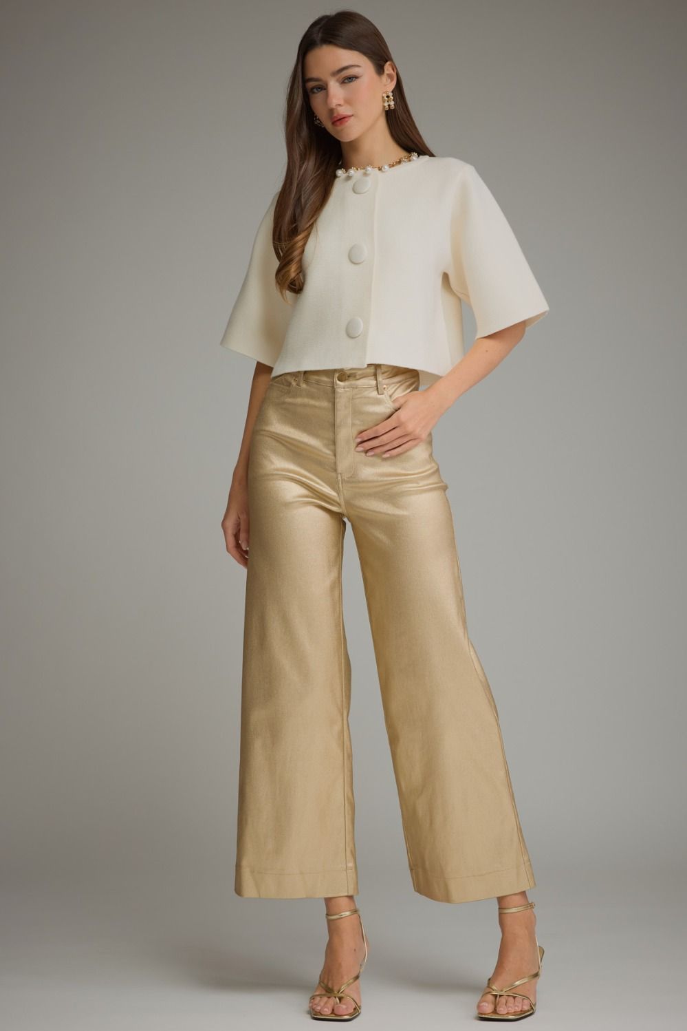 Full-length view of gold metallic wide leg pants styled with a white top