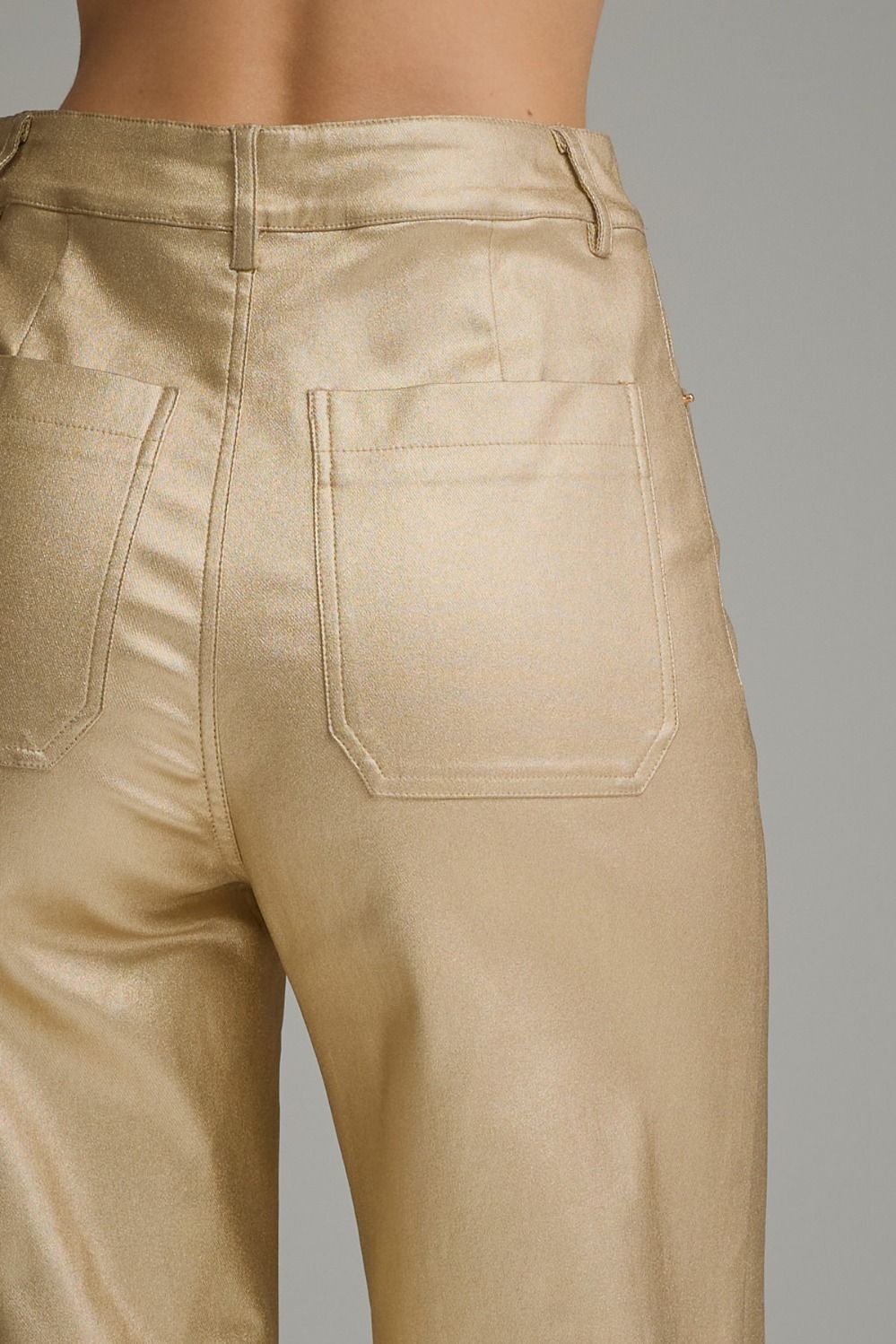 Close-up of gold metallic pants back pocket