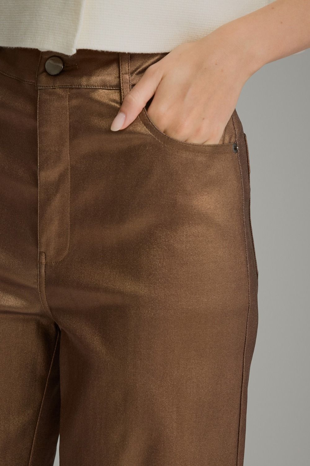 Close-up of metallic brown pants front pocket and belt loops