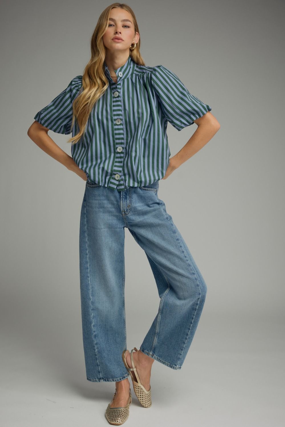 Full-length view of hunter green stripe puff sleeve top styled with jeans