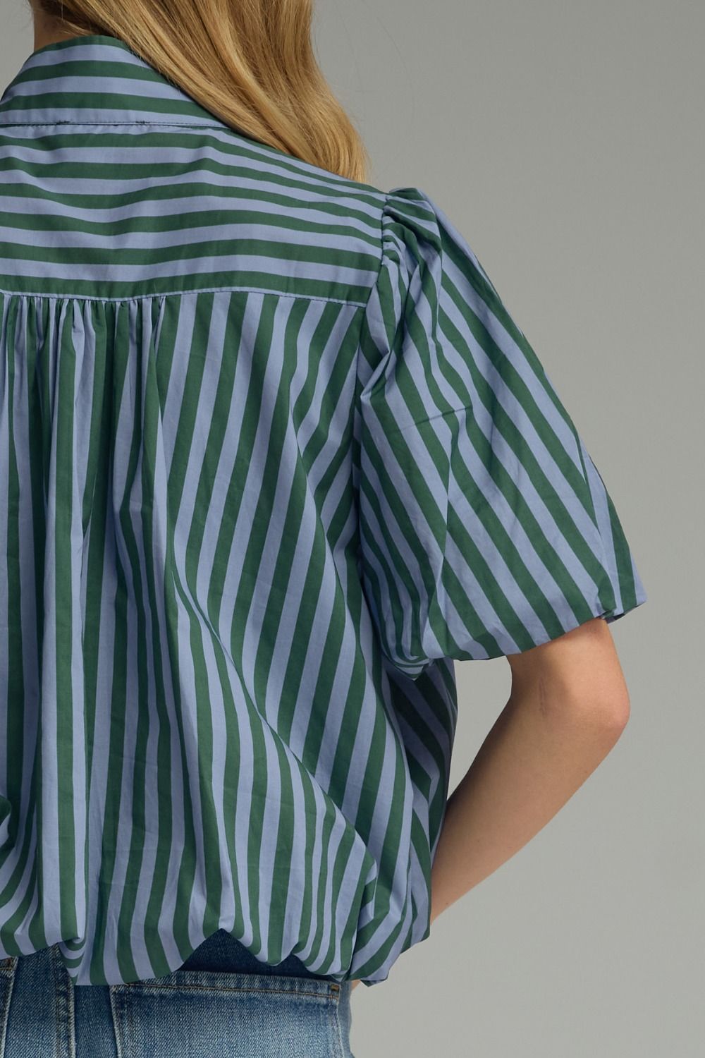 Close-up of shoulder and back shirring on hunter green stripe top