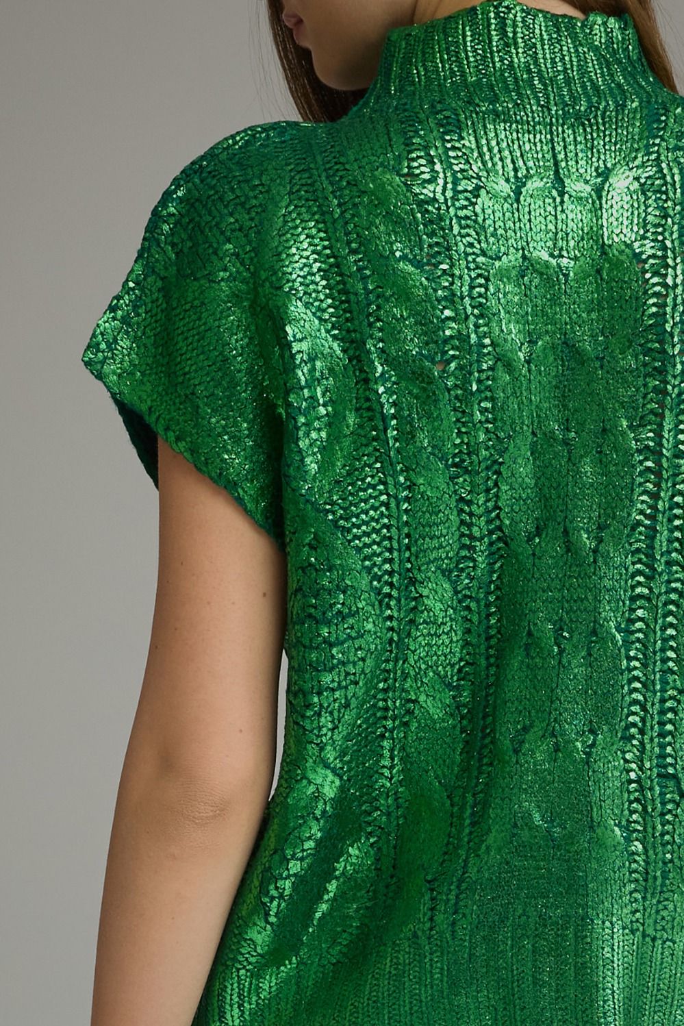 Close-up back detail of metallic green cable knit sweater top