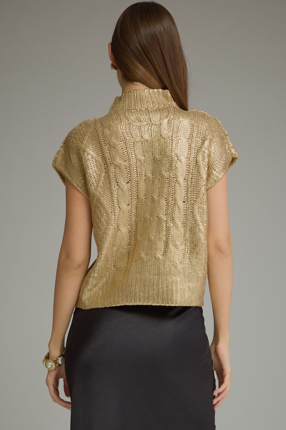 Back view of metallic gold cable knit cap sleeve sweater top