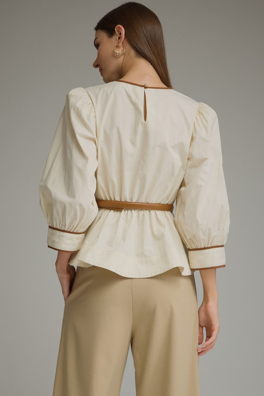 Back view of ecru puff sleeve top showing button closure