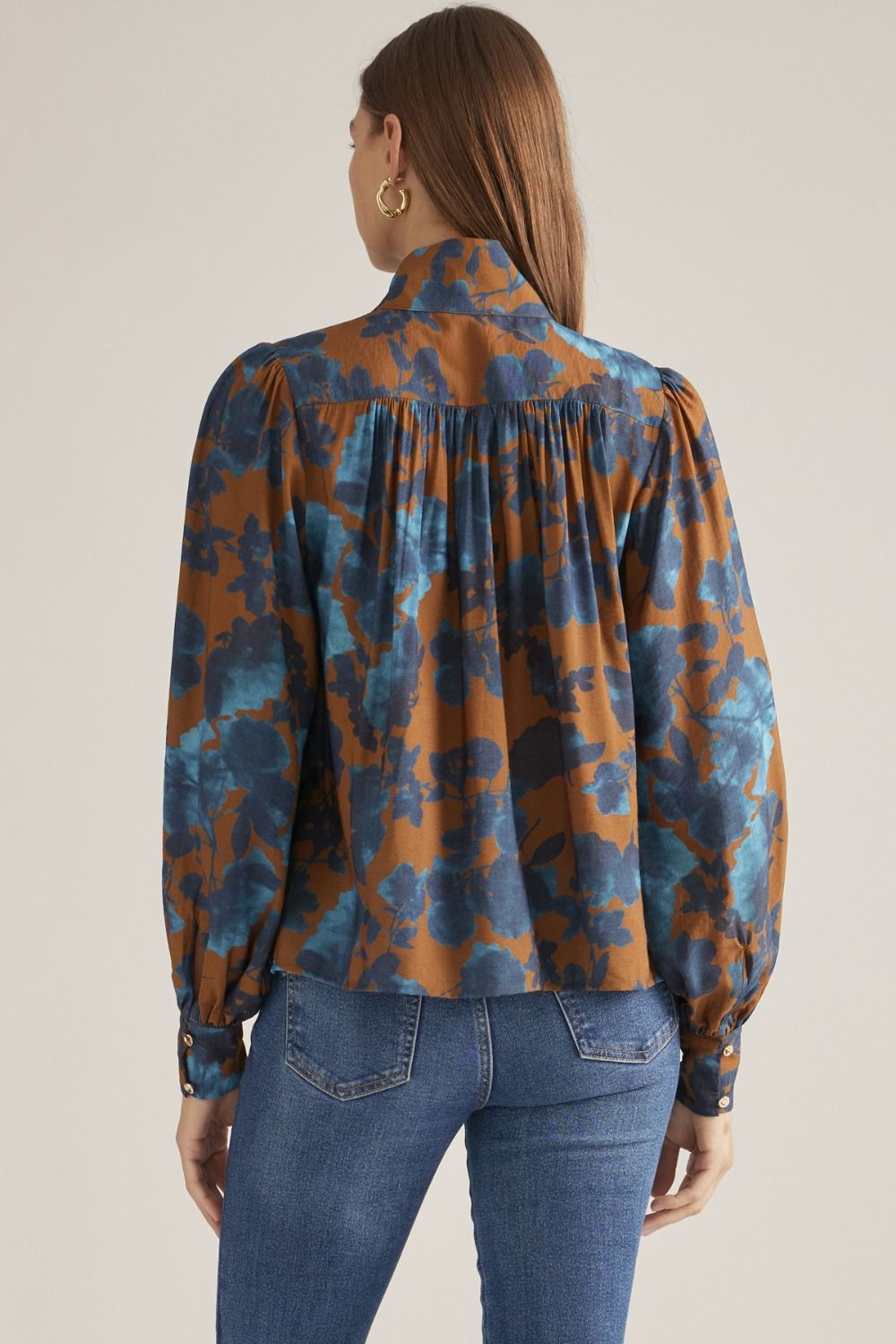 Back view of camel floral blouse with gathered back yoke
