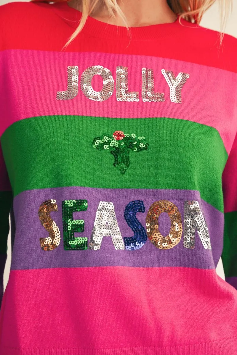 Close-up of the striped knit with silver sequin JOLLY at the chest and multicolor sequin SEASON at the hem