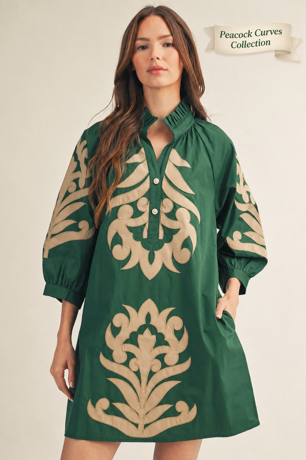 Woman wearing a green dress with beige floral patterns on a beige background