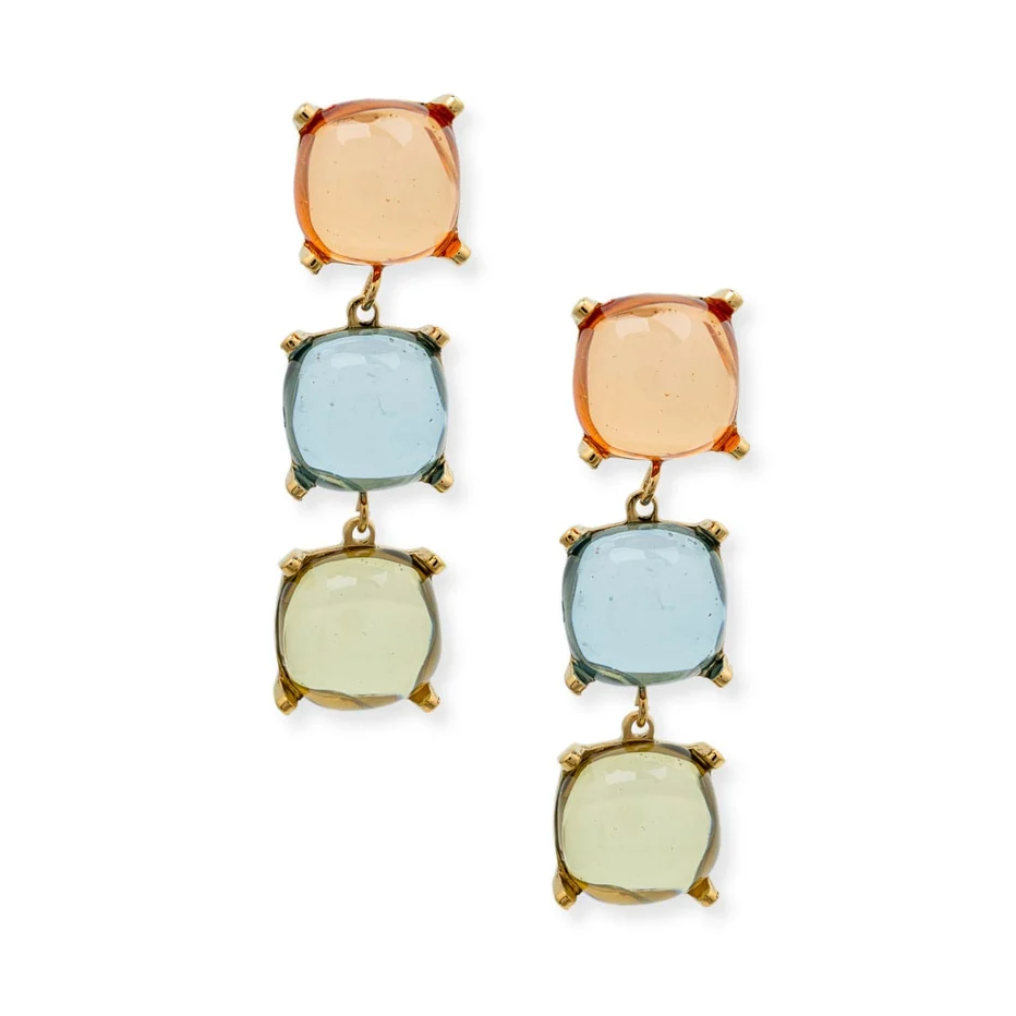A pair of gold drop earrings featuring three stacked square gemstones in peach, light blue, and pale yellow-green, set against a plain white background.