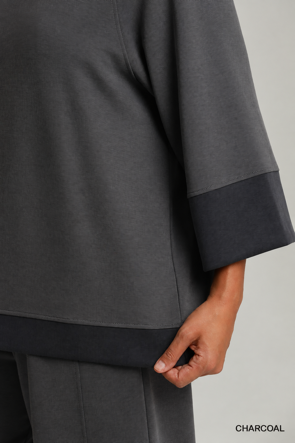 Model wearing a charcoal color-block CloudKnit raglan sleeve top