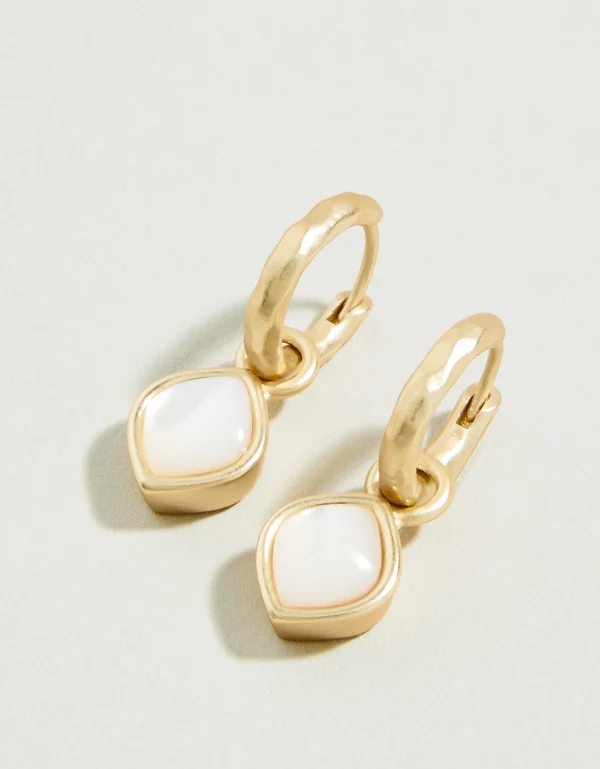 Pearl drop hoop earrings on a white background.