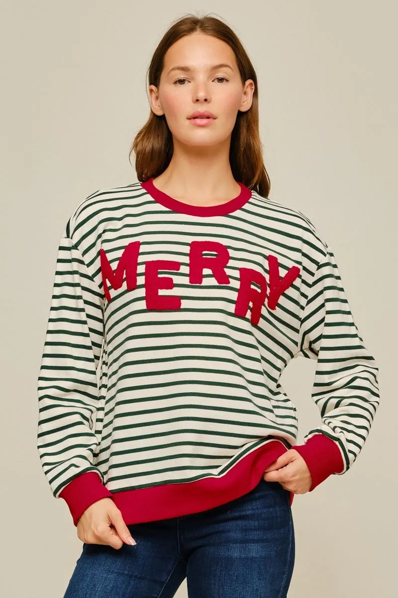 Cream and green striped pullover with red MERRY lettering and red trim, worn with jeans