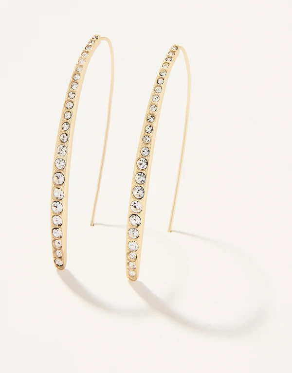 Gold-tone hoop earrings embellished with a row of clear rhinestones, displayed on a clean off-white background.