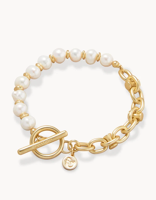 Gold bracelet with pearl beads on a white background
