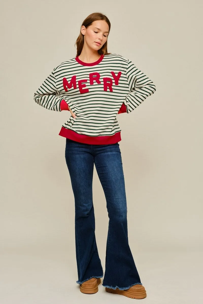 Full-length view of the Merry Little Stripe Top with flare jeans and brown boots