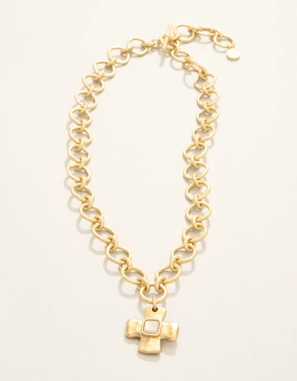 Gold chain necklace with a cross pendant on a white background