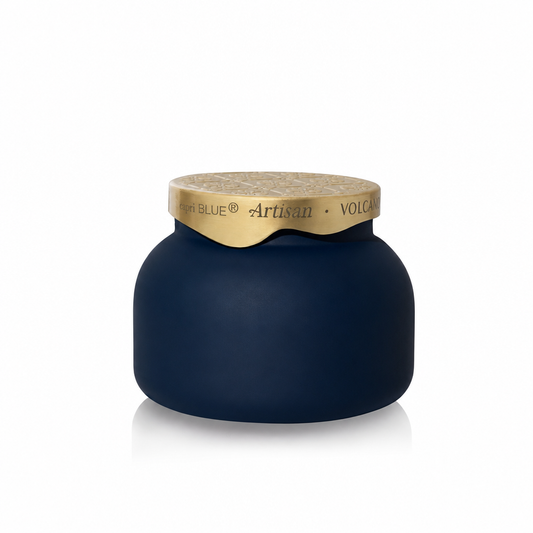 Volcano Terrazza Velluto Signature Candle in a navy jar with a sculpted gold lid