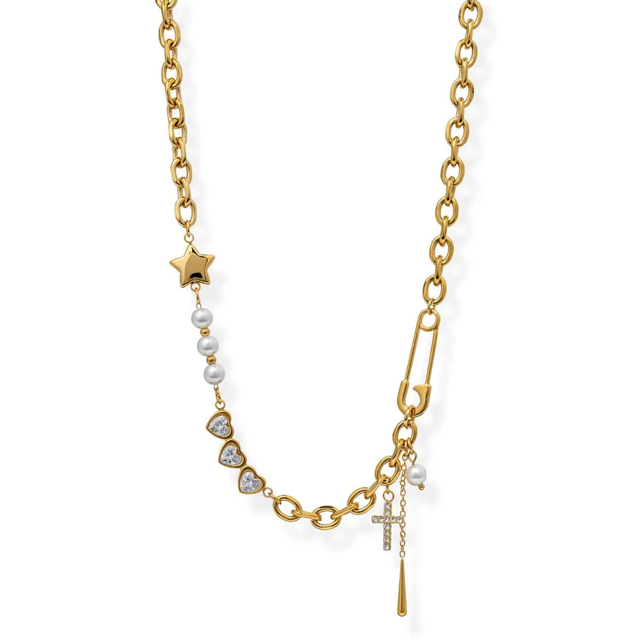 A gold chain necklace featuring a safety pin clasp, a small gold star, white faux pearls, heart-shaped crystal details, and a dangling cross charm, shown on a plain white background.