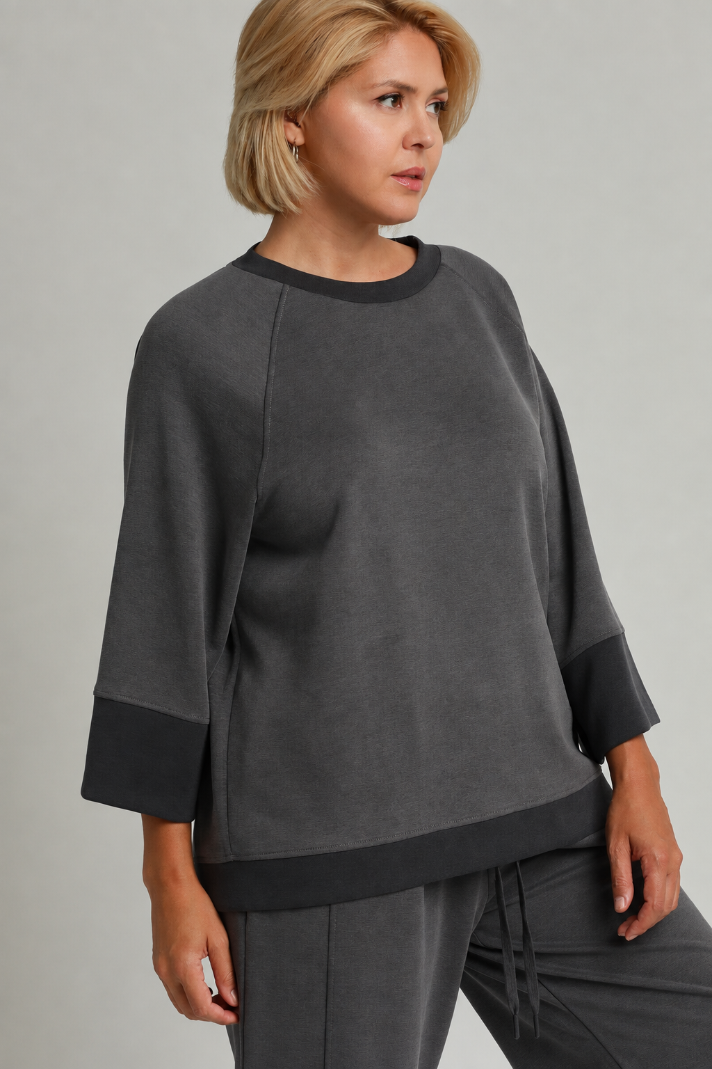 Model wearing a charcoal color-block CloudKnit raglan sleeve top
