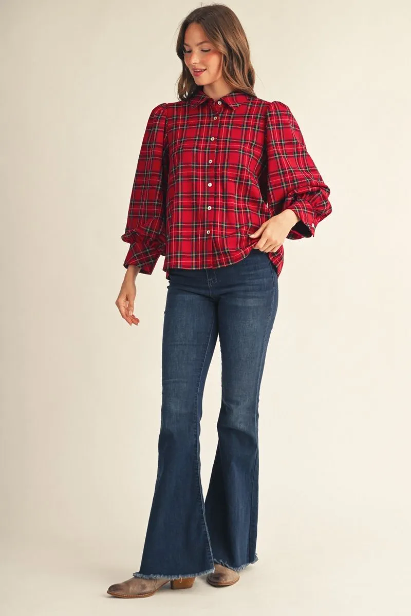 Full-length view of the red plaid puff sleeve top with flare jeans and boots