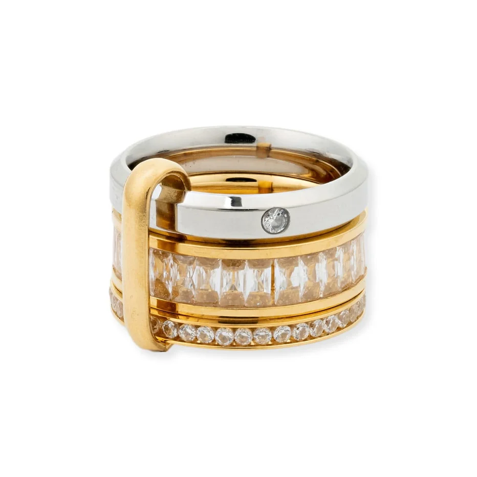 A two-tone gold and silver ring with clear gemstones, featuring a wrap-around design with a small round diamond on a white background.