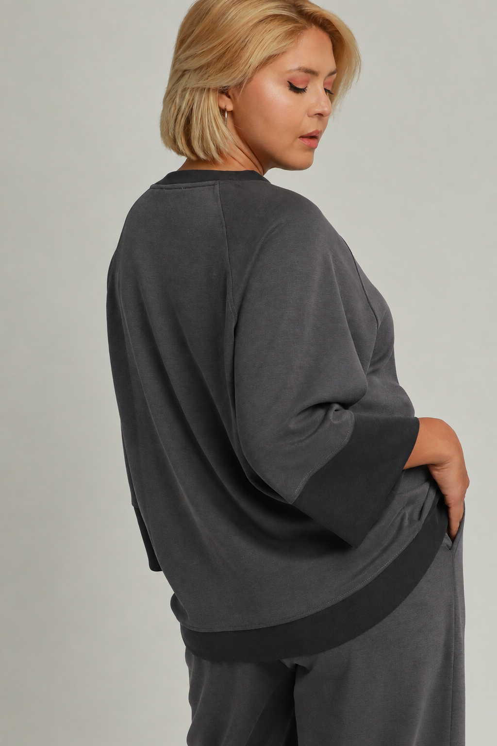 Model wearing a charcoal color-block CloudKnit raglan sleeve top