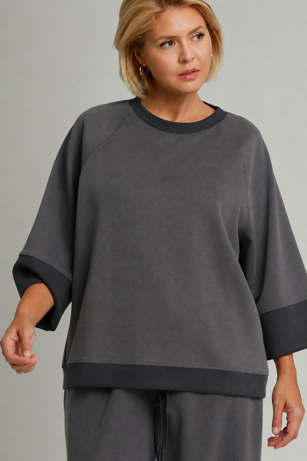 Model wearing a charcoal color-block CloudKnit raglan sleeve top