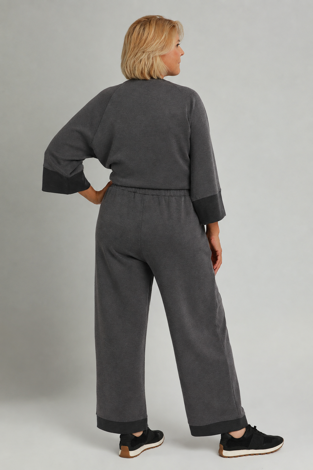 Model wearing a charcoal color-block CloudKnit outfit