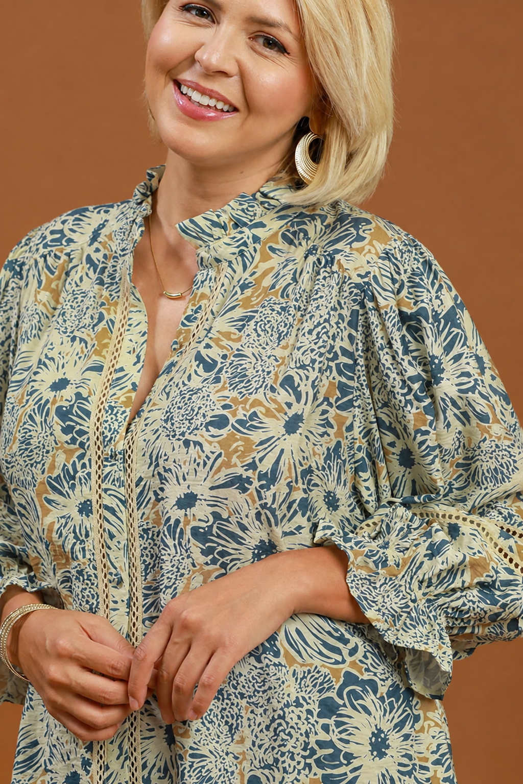 Model wearing a floral print lace trim blouse