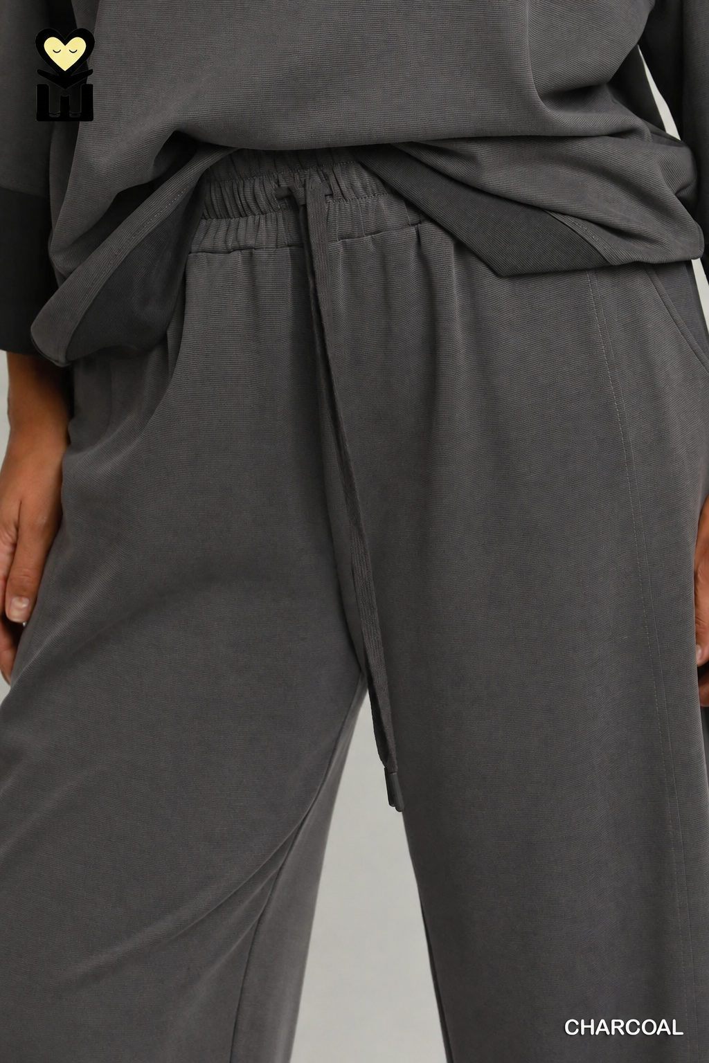 Model wearing charcoal color-block CloudKnit pants