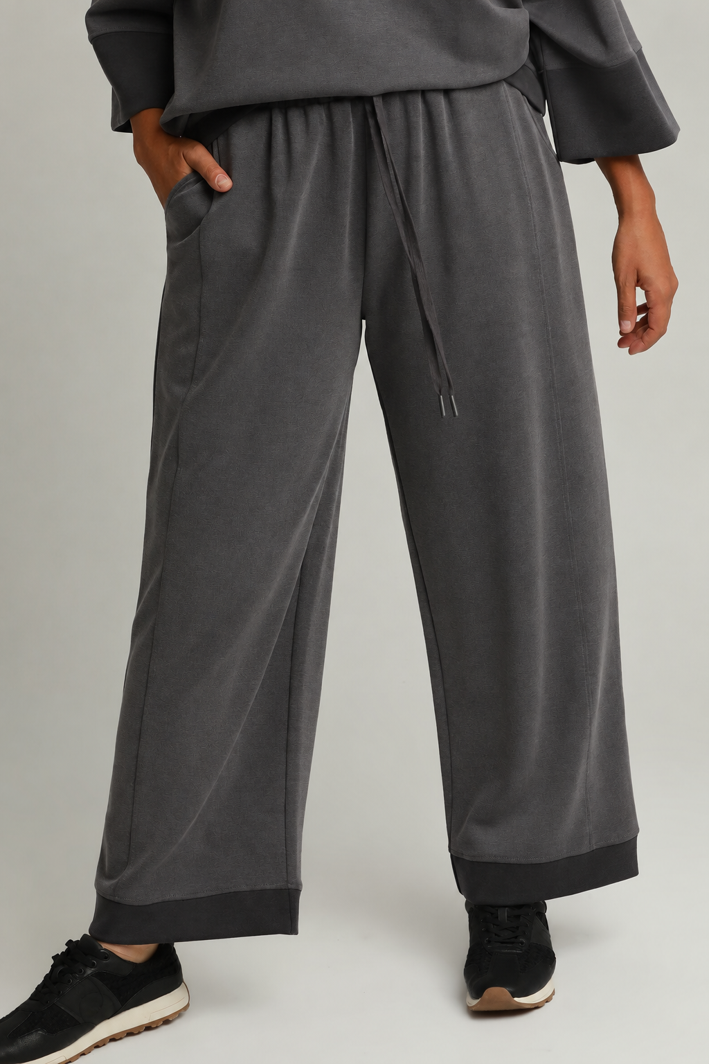 Model wearing charcoal color-block CloudKnit pants