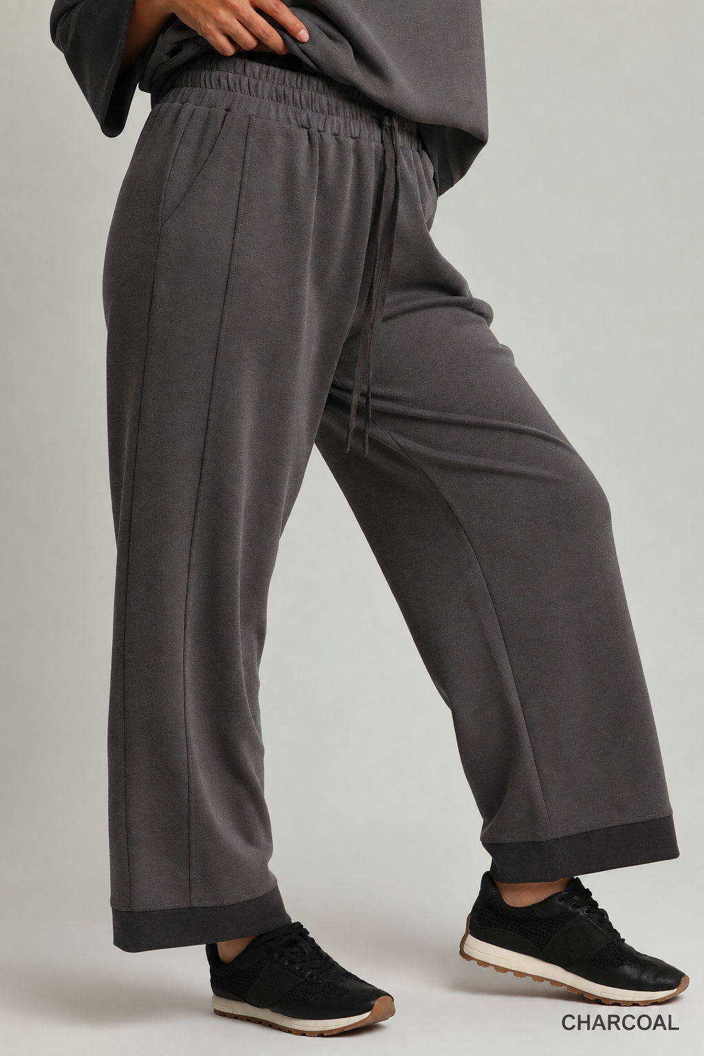 Model wearing charcoal color-block CloudKnit pants