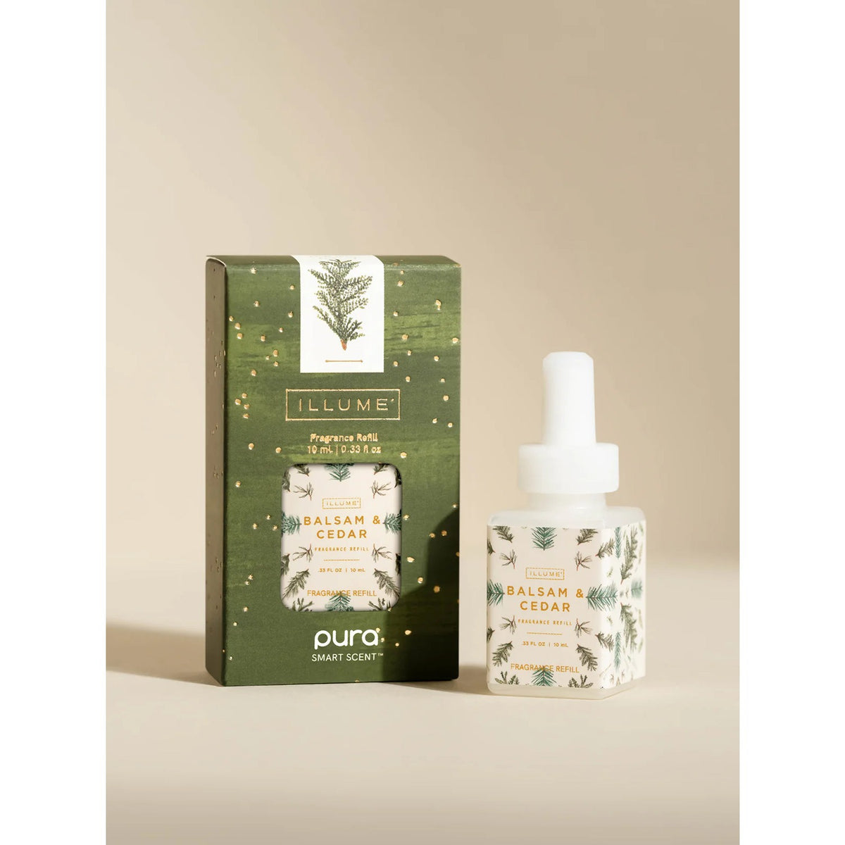 Illume Balsam & Cedar Pura smart vial beside green evergreen-print Illume gift box